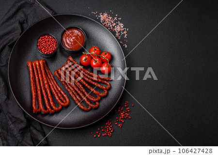 Delicious thin smoked hunting sausages with salt, spices and herbs Delicious thin smoked hunting sausages with salt, spices and herbs 106427428