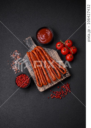 Delicious thin smoked hunting sausages with salt, spices and herbs Delicious thin smoked hunting sausages with salt, spices and herbs 106427432