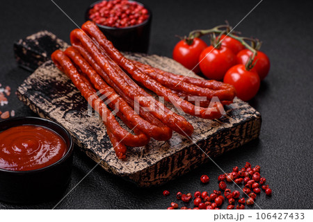 Delicious thin smoked hunting sausages with salt, spices and herbs Delicious thin smoked hunting sausages with salt, spices and herbs 106427433