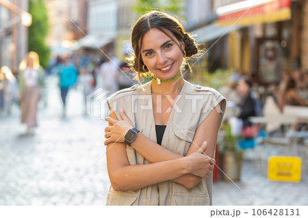 Happy young woman smiling looking away dreaming, resting, good news, feel satisfied in city street Happy young woman smiling looking away dreaming, resting, good news, feel satisfied in city street 106428131