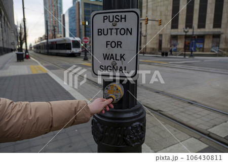 Young girl pressing button to walk across Train crosswalk in Jersey City New Jersey USA Young girl pressing button to walk across Train crosswalk in Jersey City New Jersey USA 106430811