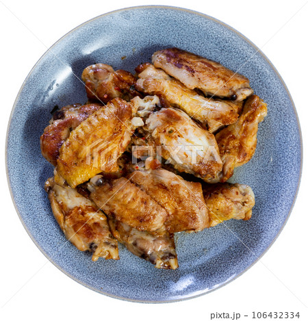 There is hearty snack on plate - large portion of fried chicken wings 106432334