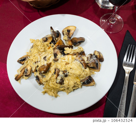 Fried scrambled egg with champignon mushroom, several slices of bran bread Fried scrambled egg with champignon mushroom, several slices of bran bread 106432524
