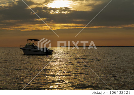 sun set and shadows of boats on a ocean in summer 106432525