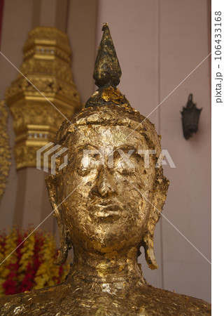 The face of the golden standing Buddha in close-up covered with a sheet of gold paper which shows the respect of the people at Phra Pathom Chedi in Nakhon Pathom Province , Middle of Thailand. The face of the golden standing Buddha in close-up covered with a sheet of gold paper which shows the respect of the people at Phra Pathom Chedi in Nakhon Pathom Province , Middle of Thailand. 106433168