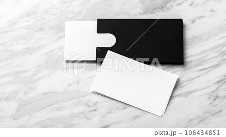 Business card mockup with black paper card holder on white marble background 106434851