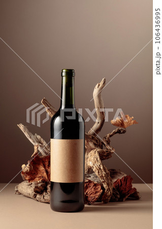 Bottle of red wine with a composition of old wood. Bottle of red wine with a composition of old wood. 106436995
