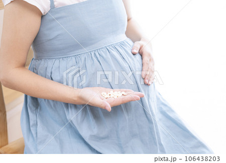 妊婦の女性が薬を摂取するイメージ 106438203
