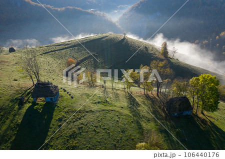 Aerial view of autumn countryside farm, with abandoned wooden houses and barns in the mountains 106440176