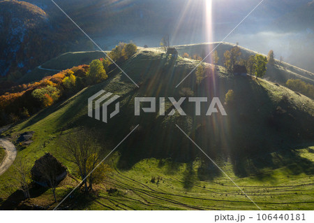 Aerial view of autumn countryside farm, with abandoned wooden houses and barns in the mountains 106440181