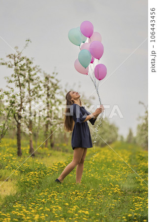 girl with balloons in the field girl with balloons in the field 106443456