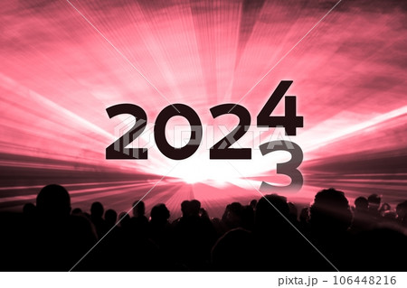 Turn of the year 2023 2024 red laser show party. Luxury entertainment with people crowd audience silhouettes at new year celebration. Premium nightlife event at holidays season time. Turn of the year 2023 2024 red laser show party. Luxury entertainment with people crowd audience silhouettes at new year celebration. Premium nightlife event at holidays season time. 106448216