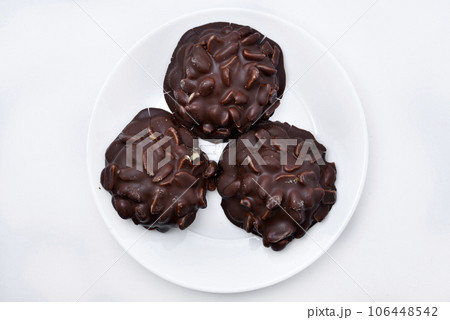 Chocolate chip cookies with nuts. Sweet appetizer on a white plate. Chocolate chip cookies with nuts. Sweet appetizer on a white plate. 106448542