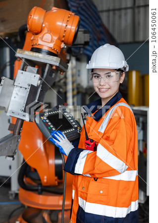 female technician engineer looking at camera holding remote control automation robotics female technician engineer looking at camera holding remote control automation robotics 106450061