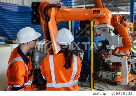 Mechanic engineer man and woman using talkie walkie are checking quality system. Mechanic engineer man and woman using talkie walkie are checking quality system. 106450232