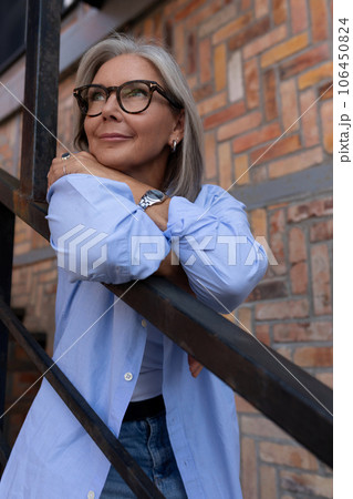 pretty fashionable middle-aged woman with gray hair dressed in summer style enjoys freedom in pretty fashionable middle-aged woman with gray hair dressed in summer style enjoys freedom in 106450824