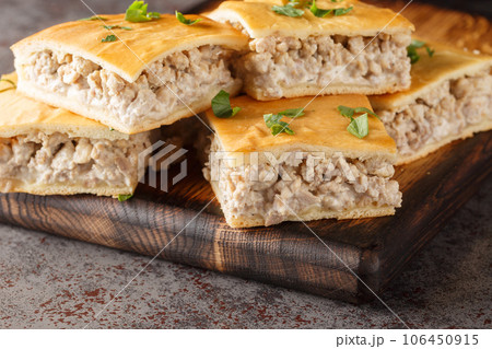 Savory pie for breakfast of italian sausages with cream cheese close-up on a wooden board. horizontal Savory pie for breakfast of italian sausages with cream cheese close-up on a wooden board. horizontal 106450915
