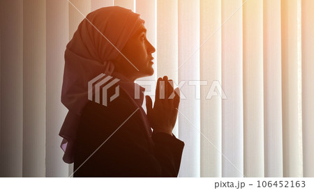 Muslim woman in hijab prays for better peaceful life 106452163