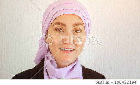 Muslim woman with excited expression looks around in studio 106452194