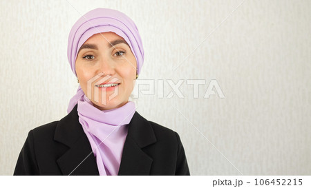 Muslim woman with excitement stands at white studio wall 106452215