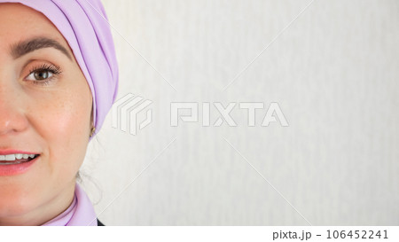Muslim woman standing with delighted expression at wall 106452241