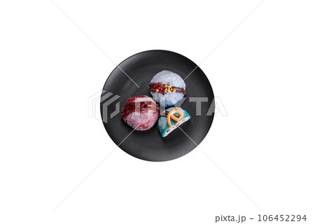 Delicious sweet colorful mochi desserts or ice cream with rice dough and toppings Delicious sweet colorful mochi desserts or ice cream with rice dough and toppings 106452294