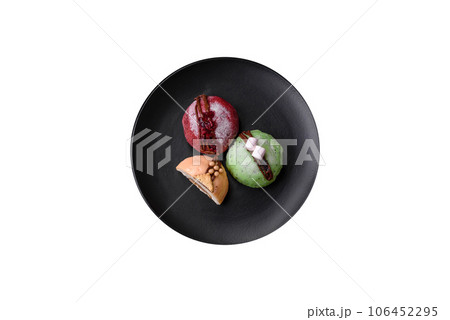 Delicious sweet colorful mochi desserts or ice cream with rice dough and toppings Delicious sweet colorful mochi desserts or ice cream with rice dough and toppings 106452295
