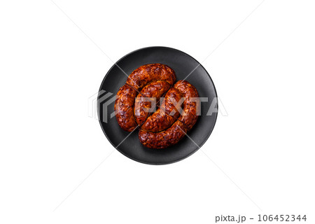 Delicious grilled sausage in the form of a ring with salt, spices and herbs Delicious grilled sausage in the form of a ring with salt, spices and herbs 106452344