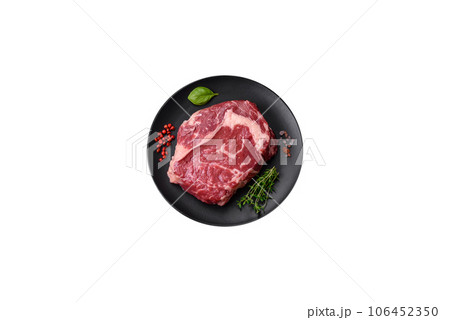 Fresh, raw beef steak with salt, spices and herbs Fresh, raw beef steak with salt, spices and herbs 106452350