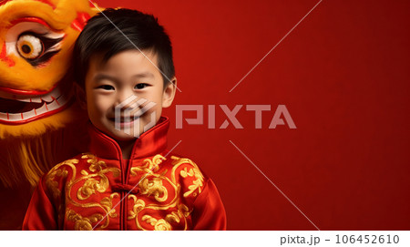 Little Asian boy in red dragon costume on red background with space for text. High quality photo 106452610