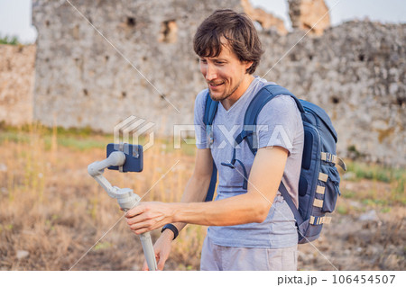 Man tourist explores Aspendos Ancient City. Aspendos acropolis city ruins, cisterns, aqueducts and old temple. Aspendos Antalya Turkey. turkiye Man tourist explores Aspendos Ancient City. Aspendos acropolis city ruins, cisterns, aqueducts and old temple. Aspendos Antalya Turkey. turkiye 106454507