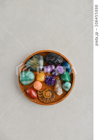 Different healing crystals on a wooden tray, top view 106455898