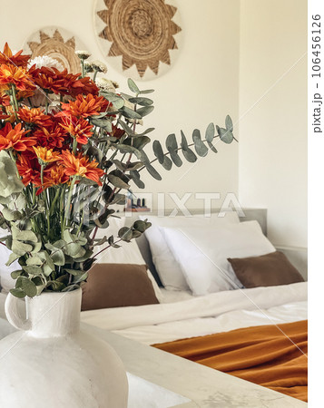 Bouquet of orange chrysanthemums in bedroom 106456126