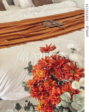 Bouquet of orange chrysanthemums in bedroom Bouquet of orange chrysanthemums in bedroom 106456134