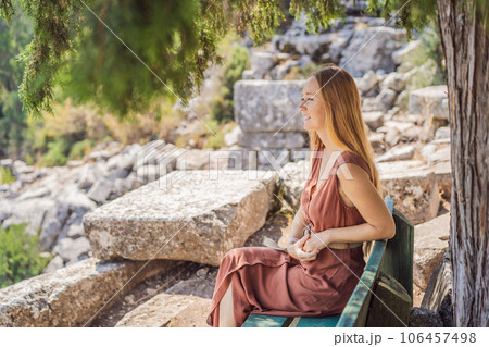 Woman tourist explores Stunning Ancient Theater of Termessos Ancient City turkiye, GO Everywhere Woman tourist explores Stunning Ancient Theater of Termessos Ancient City turkiye, GO Everywhere 106457498