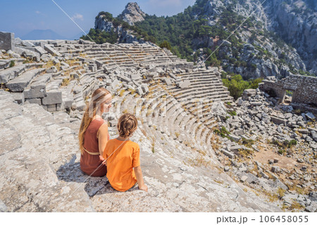 mother and son tourists explores Stunning Ancient Theater of Termessos Ancient City. Traveling with kids concept. turkiye, GO Everywhere 106458055