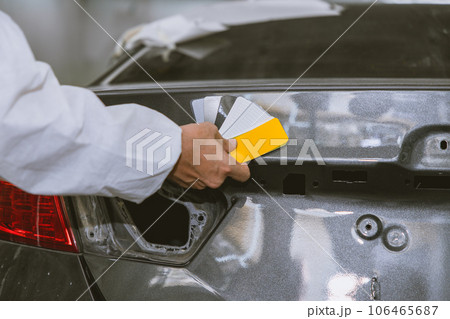 car body painter painting select paint colors using sample card for pick choice color shade in auto garage body workshop car body painter painting select paint colors using sample card for pick choice color shade in auto garage body workshop 106465687