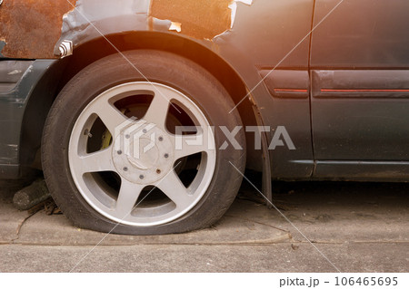 car with flat tire parking outdoor in hot weather damaged old broken vehicle need to service 106465695