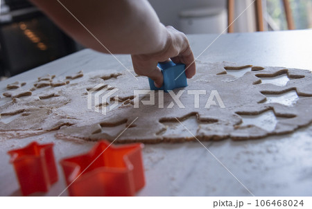 Hands of little 6 years old child with cookies in shape of star. cooking concept Hands of little 6 years old child with cookies in shape of star. cooking concept 106468024
