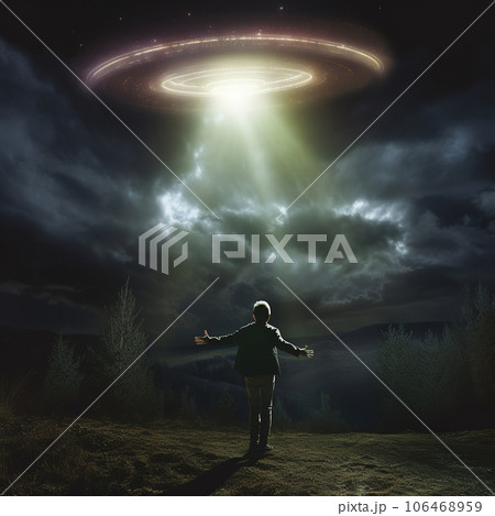 A man looks at a UFO in the sky. The man stretched out his hands and looks at the flying alien ship. 106468959