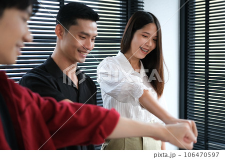 Successful business team giving fist bump at meeting. Concept of corporate unity, motivating, solidarity, trust 106470597