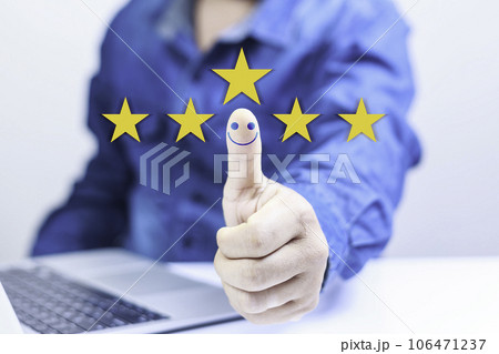 Customer service satisfaction concept. Businessman Hand with thumb up Positive emotion smiley icon. questionnaire for experience or customer satisfaction research. Five star show on virtual screen. 106471237