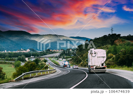 Concrete Transport Truck In-transit Mixer Unit In Motion On Country Road, Freeway. Freeway Motorway Highway. Business Drive Transportation And Development Concept. Concrete Truck Mixer. Concrete Transport Truck In-transit Mixer Unit In Motion On Country Road, Freeway. Freeway Motorway Highway. Business Drive Transportation And Development Concept. Concrete Truck Mixer. 106474639