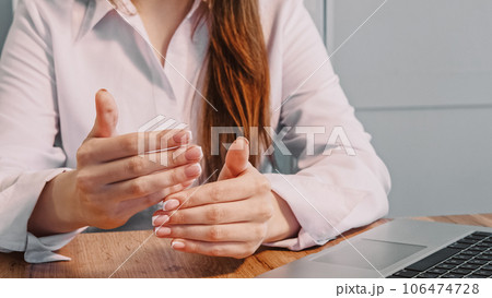 Coach gesticulate. Hands gesturing. Unrecognizable woman office worker explaining sitting at table with laptop at workplace. 106474728