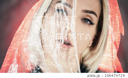 Laser surgery. Vision correction. Aesthetic medicine. Beautiful woman half covered face with glitch noise animation plastic film on neon red light. Laser surgery. Vision correction. Aesthetic medicine. Beautiful woman half covered face with glitch noise animation plastic film on neon red light. 106474729