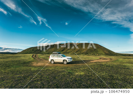 4wd car parked on remote wilderness and mossy hill in summer at Icelandic Highlands 106474950