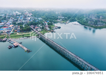 Traditional Mon village in morning foggy and wooden Mon bridge in the dam at Sangkhlaburi 106474951