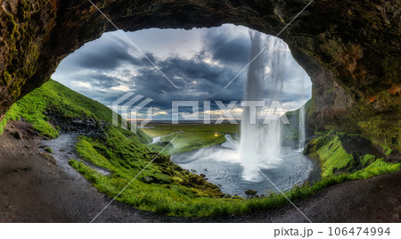 Natural cave with Seljalandsfoss waterfall flowing in summer at Iceland Natural cave with Seljalandsfoss waterfall flowing in summer at Iceland 106474994