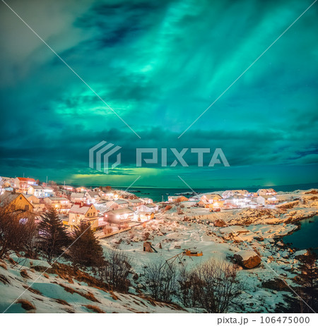 Aurora borealis glowing over scandinavian village on coastline in winter at Lofoten Islands, 106475000