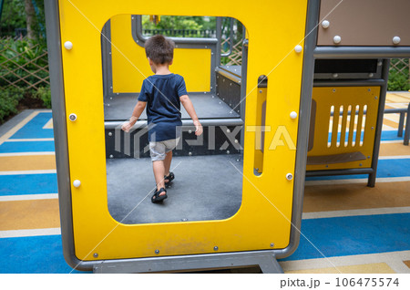 A toddler is playing on toys in the park A toddler is playing on toys in the park 106475574